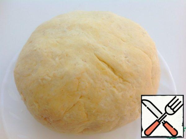 Pour in kefir or any dairy product that is at hand. Use a fork to mix the flour with kefir. Quickly form a dough ball.