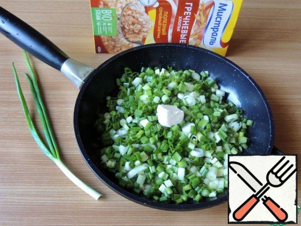 For the filling, cut the green onions and sweat it with a piece of butter for 5 minutes.