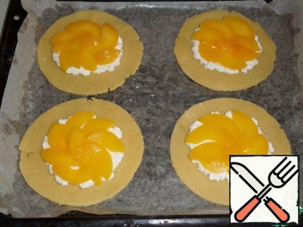 Spread sliced peaches on top of the cheese.
