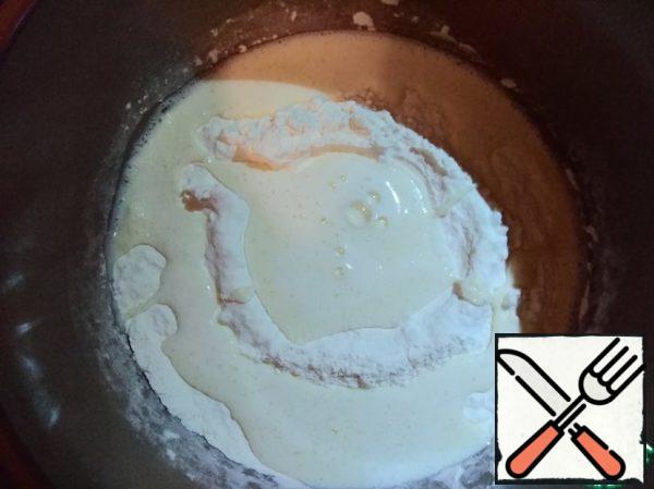 Add the mixture slowly into the flour and knead the dough. To make the dough easier to knead, moisten your hands with vegetable oil. The dough should lag behind the hands and walls of the pan.
