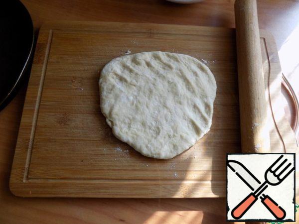 On the Board the ball flattened by hand. Rolled the dough into a circle D-24 cm, this diameter I have a non-stick pizza. You can make a Galette on the protvin, covered with baking paper.