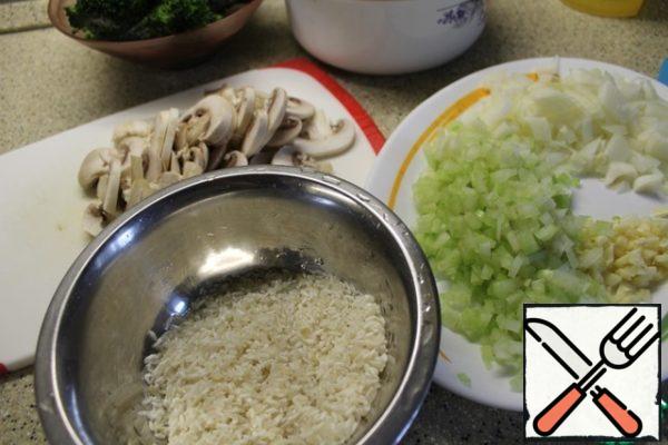 Rice wash, mushrooms cut into plates, onion,garlic and celery chopped.