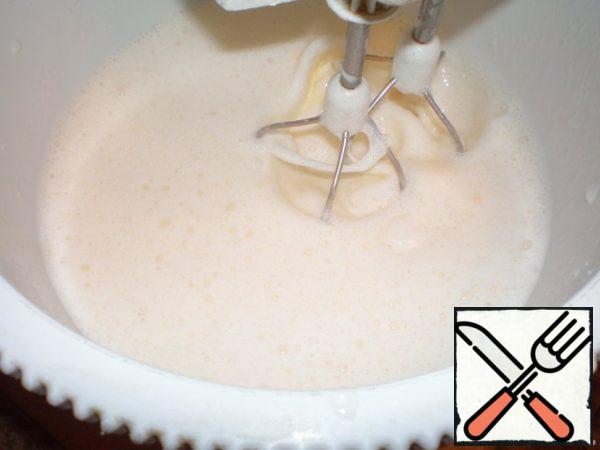 Add milk, vanilla sugar, a pinch of salt.
Add softened butter, baking powder with flour.