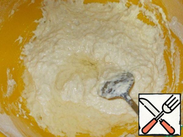 Spoon knead the viscous dough. Add vegetable oil and another half a Cup of flour. Make dough.
