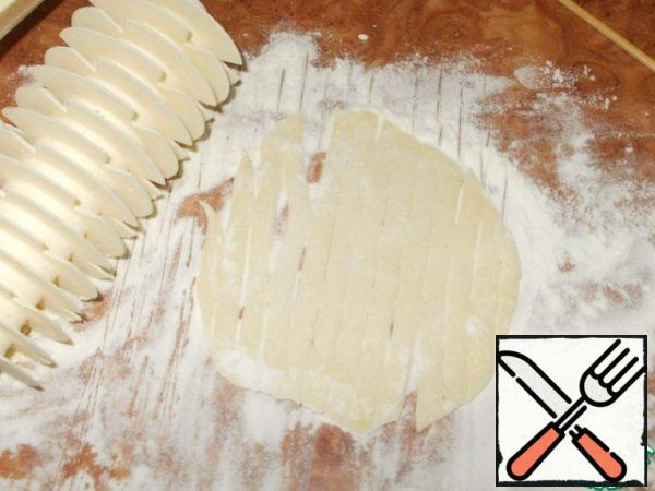 With a knife for cutting the dough, simply sprinkle the grate with flour and roll it out over the dough.