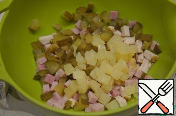 Lightly squeeze pineapple from excess syrup and cut into cubes, add to salad.
