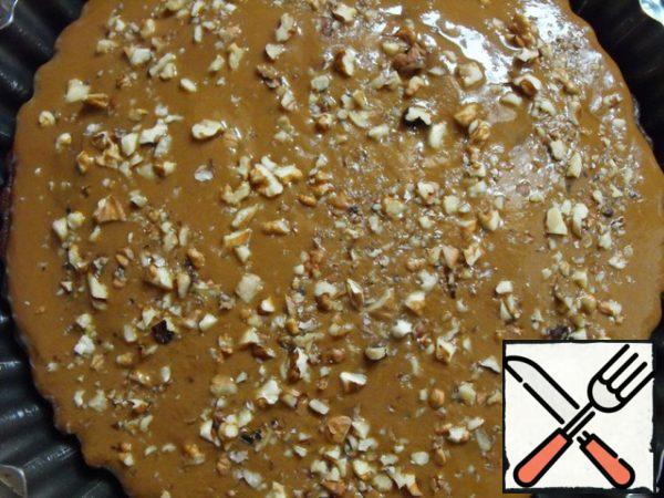 Pour this mixture over the hot cake and sprinkle with the remaining walnuts.