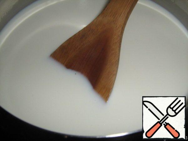 To begin with, take a saucepan with a thick bottom, if there is no copper cookware,
let's pour milk into it and put it on fire.