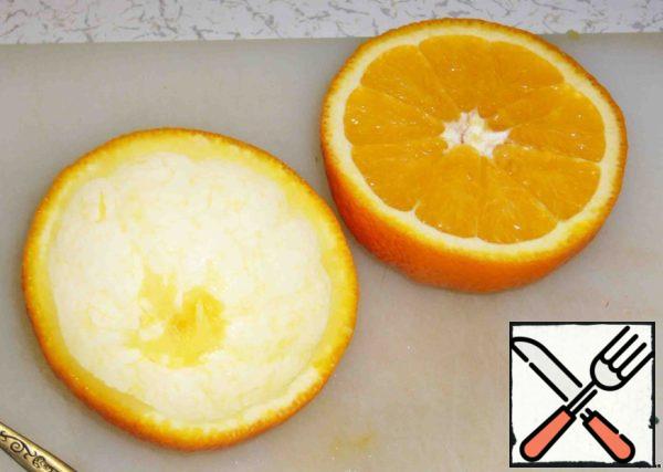 Cut the orange into two equal parts.
