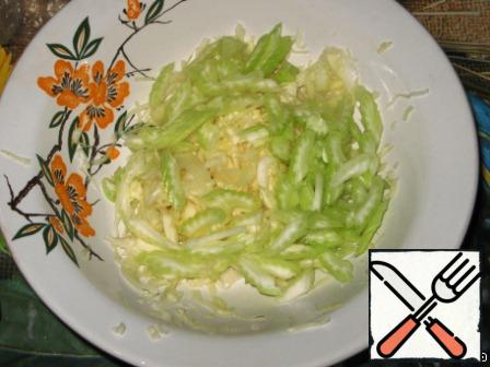Add the chopped celery stalks to the cabbage.