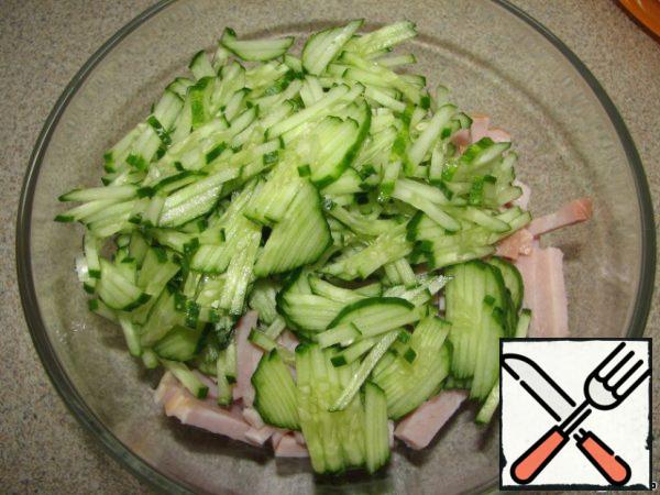Cucumber is also cut into strips, add to ham.