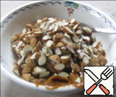Nuts finely chop with a knife and connect with condensed milk.
