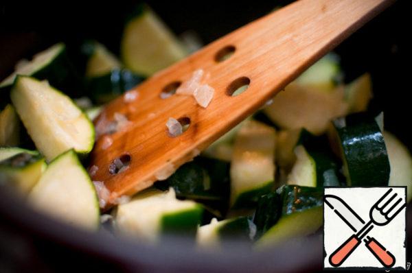 Add zucchini to the onion and simmer for a few minutes.