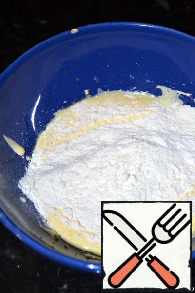 To whipped yolks add flour, mix with a spatula.