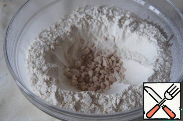 Sift the flour into a wide, deep bowl, make a recess, crumble the yeast into it,
