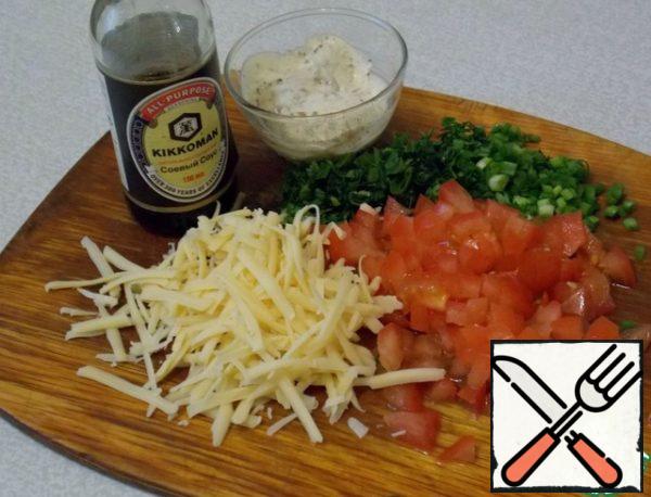 Sour cream mix with spices and sauce. Greens, tomatoes and green onion chopped cut. Cheese grate on a small grater. Mix it all together.
