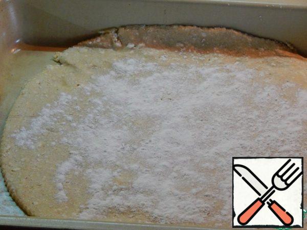 Roll out the dough on a greased baking sheet. Top sprinkle with starch, retreating from the edges sm 3.