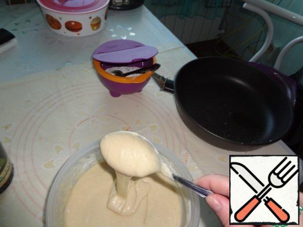 Add flour and mix, the dough should be in consistency as a thick sour cream. Pour into a mold greased with vegetable oil and send in the oven.