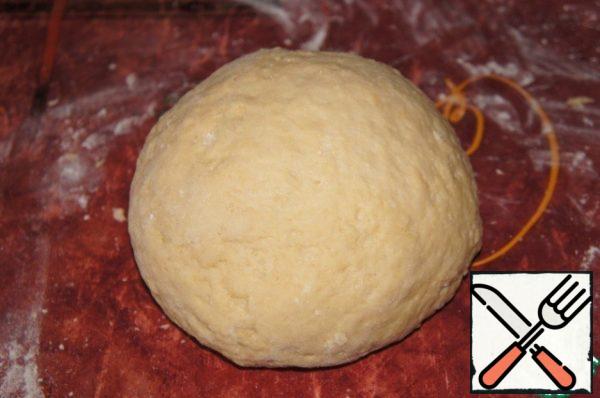 Knead the dough quickly. If thick, add a couple of tablespoons of cold water. Roll the dough into a ball and put it in the refrigerator.
