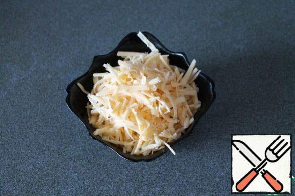 Grate the cheese on a coarse grater.
