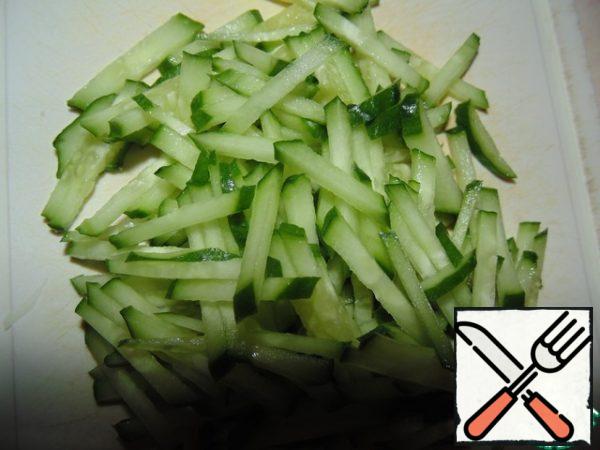 Cut cucumber into strips.