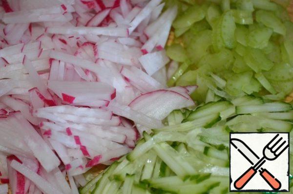 Radish and cucumber cut into strips. Celery petiole cut lengthwise, and then cut into thin slices.