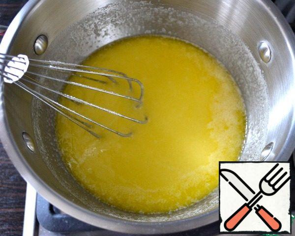 In another saucepan put butter, cut into pieces and put on fire. Once the butter starts to melt, add sugar and stir.