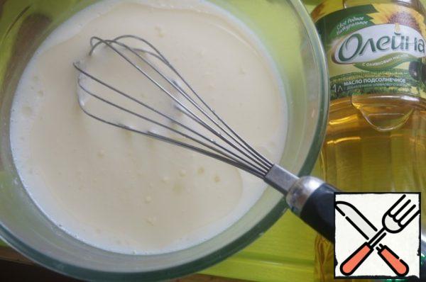 For pancakes: dissolve salt in warm milk. Add eggs, sunflower oil, mix everything.
Mix the flour with baking powder and add it to the dough in small portions.
Mix everything well so that there are no lumps.
