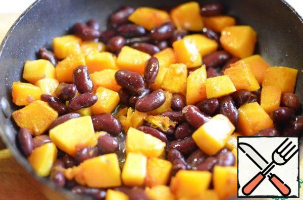 Cut the pumpkin into cubes and fry in a small amount of vegetable oil, add the beans, season with salt and pepper and fry a little more.
