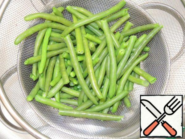 Green beans blanch 5 minutes in boiling water and throw in a colander. Chopped woods from a set of kebabs in advance to soak in water.