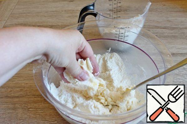 So, take the butter, better cold, mix with powdered sugar and flour. Grind into crumbs, then add the egg, water and knead the dough.
If necessary, then pour more flour.