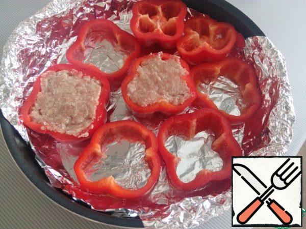 Put the prepared peppers in a baking dish on foil and fill with filling.
