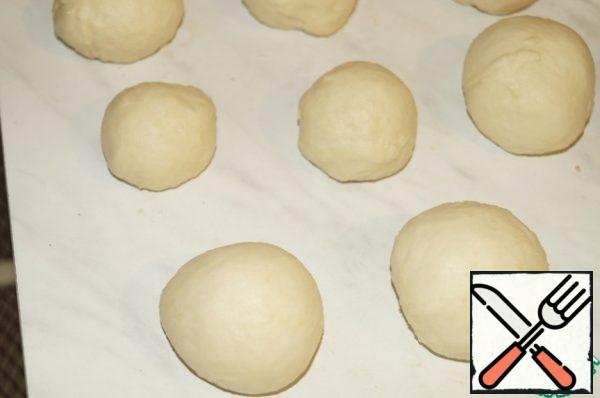 The dough should be divided into small portions and rolled into balls.