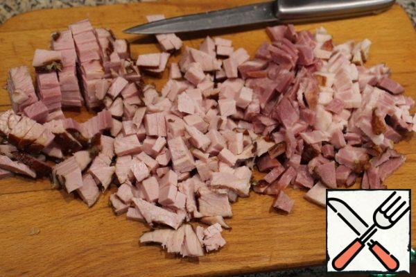 Cut the smoked meat into cubes and send to a hot, greased with vegetable oil pan. When fat is liquid, add the chopped half rings or quarter rings of onions. Fry until the onion has softened. Cool to a slightly warm state.