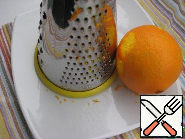 Grate the orange peel on a fine grater, I took 1/3 of the whole.
