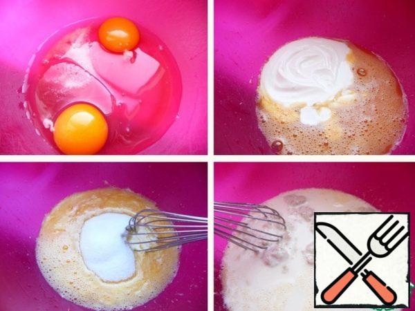 In a bowl for kneading the dough (kneading was done with your hands), break the eggs, add salt, whisk, add yogurt, stir, add sugar, vanilla sugar. Pour in the activated yeast.
