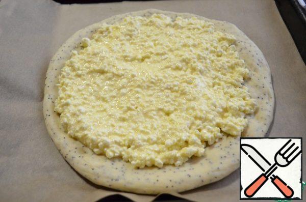 The resulting dough is divided into two parts, one slightly larger than the other. A large part of the rolled circle.