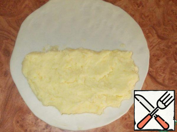 Put the filling on one half and distribute evenly, leaving the edges about a centimeter for pinching.
