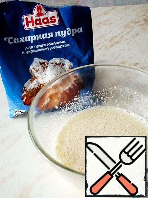 Beat eggs and powdered sugar with a mixer.
