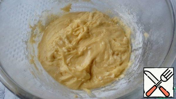 Then add flour with baking powder and mix well. The dough is thick enough. Spread half of the dough in shape, smooth.
