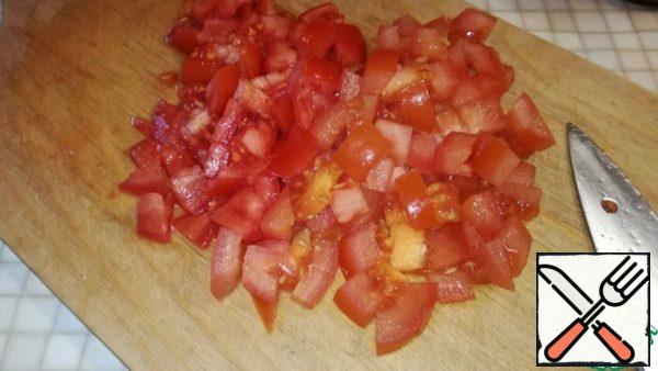 Add diced tomatoes to our vegetables, mix and simmer for 10 minutes.
