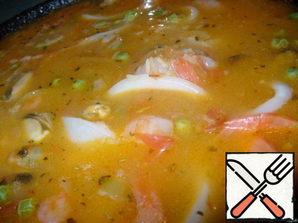 Add seafood to the pan, mix well and simmer until all the water evaporates. It will take 20-25 minutes.