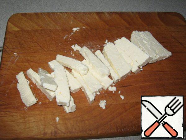 Cut the cheese into strips.
