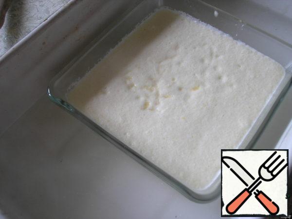 Transfer the mixture to a baking dish. Put in a large-sized form, pour in enough hot water to get up to half of the pudding.