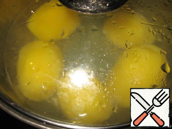 Peel and boil the potatoes.
