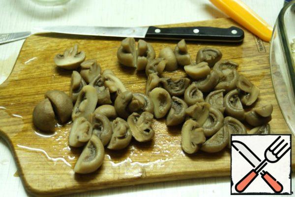 Pre-cooked mushrooms cut in half.