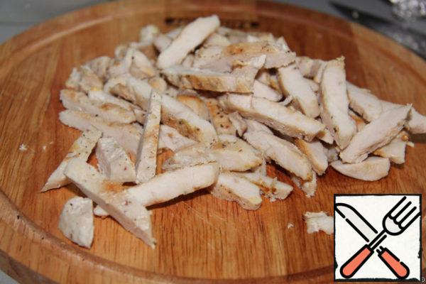 Salt and pepper the chicken breast, fry until tender and cut into strips.