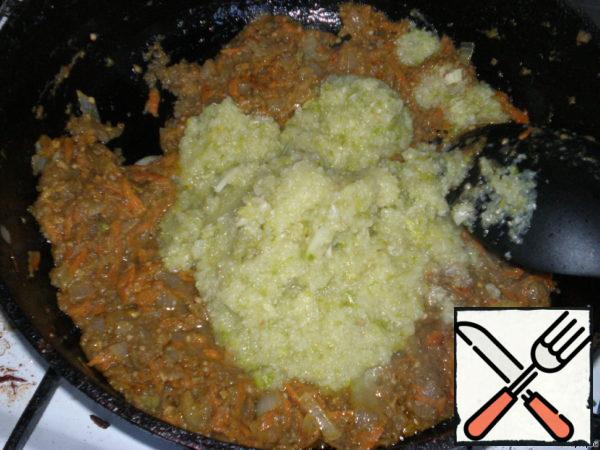 Add the chopped zucchini and mix. Fry until thickened. Add a little water, salt, sugar, ground black pepper to taste. Add vinegar. Simmer over low heat until tender. A couple of minutes before cooking, add the greens and let it brew.