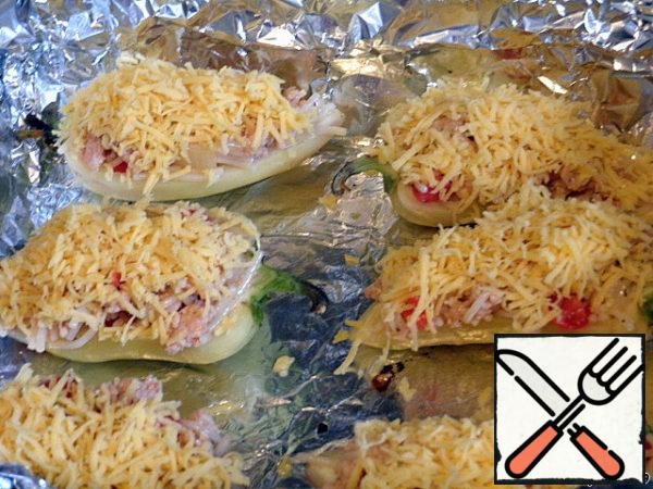 Grate the cheese on a fine grater and sprinkle them liberally with peppers. Put in a preheated oven and bake at 180 degrees for about 20 minutes.

