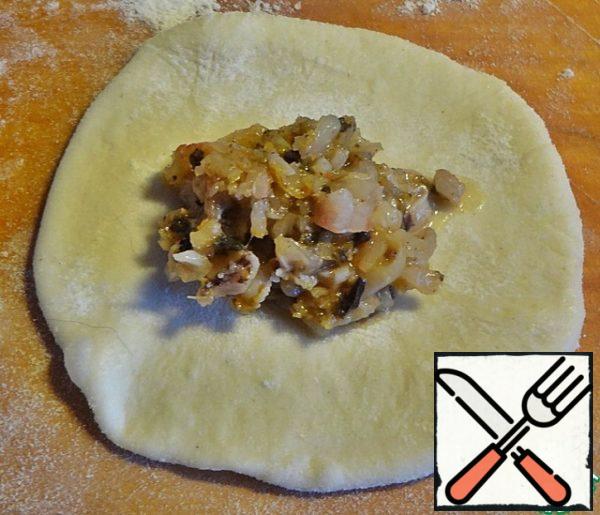 Roll out each piece and put 1 tsp of filling in the middle.
